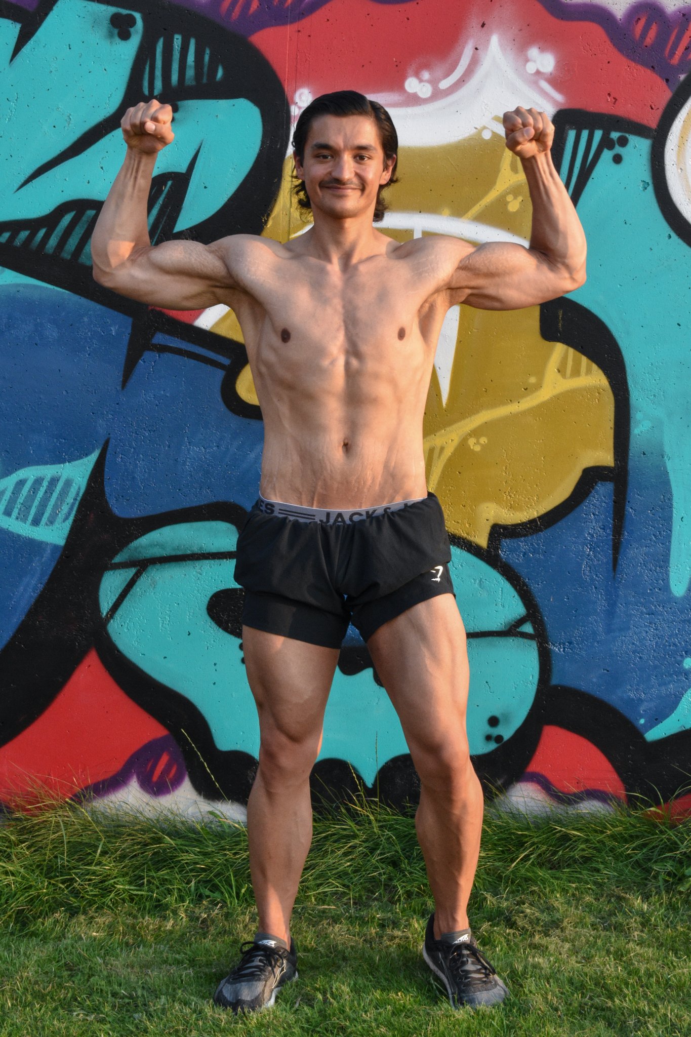 Topless man in gymshorts, posing for the camera after losing 50 kilograms (110 pounds) in 408 days.